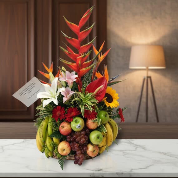 Arreglo Floral con Frutas Eclipse: Elegancia y Frescura para Regalar Arreglo floral premium 'Eclipse' con heliconias, lirios, girasoles y frutas frescas como manzanas, uvas y plátanos, sobre una